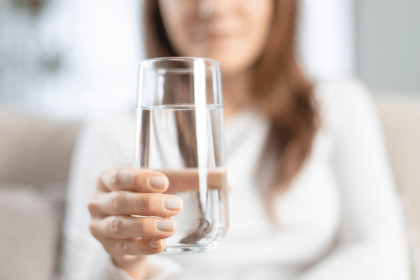 Woman drinking filtered water. 